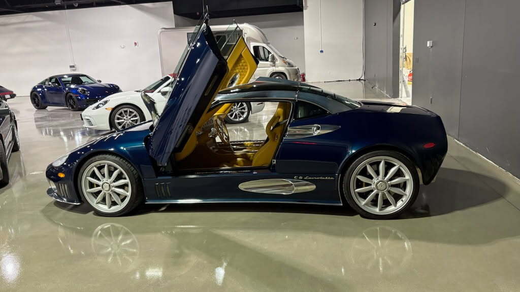 A vehicle with butterfly doors in the Archive Motor Club showroom.
